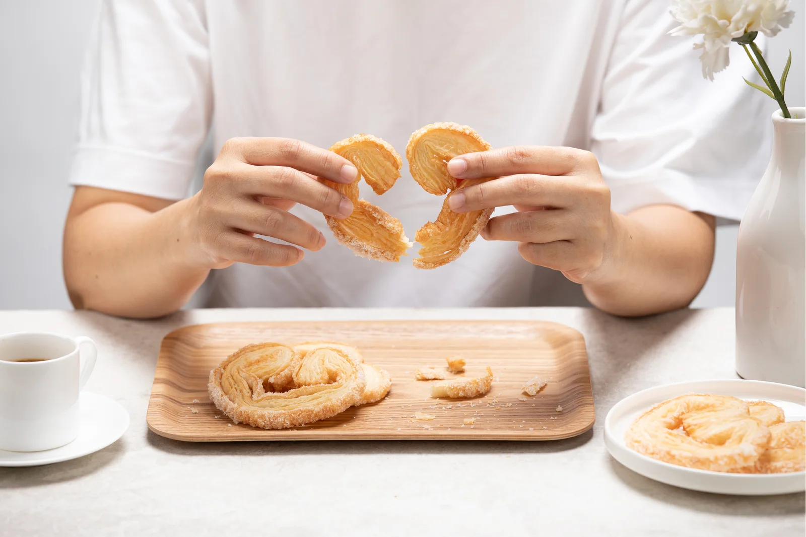 A customer enjoying a fresh Bonjour pastry at the table