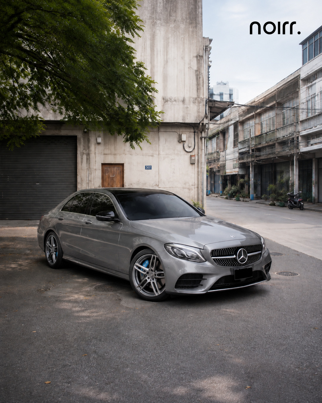 Mercedes E 350 e complete front three quarter portrait in a Bangkok courtyard