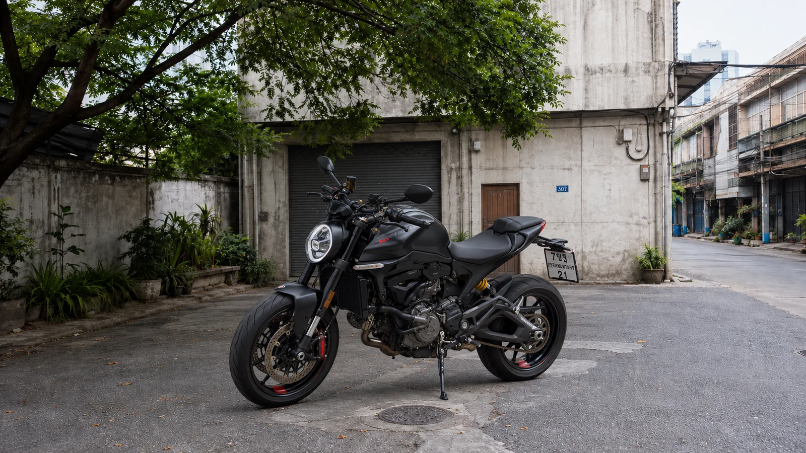 Ducati Monster SP 937 front three quarter in the Charoen Krung courtyard during daytime