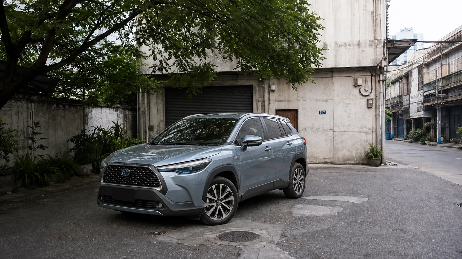 Toyota Corolla Cross front three quarter in the Charoen Krung courtyard during daytime