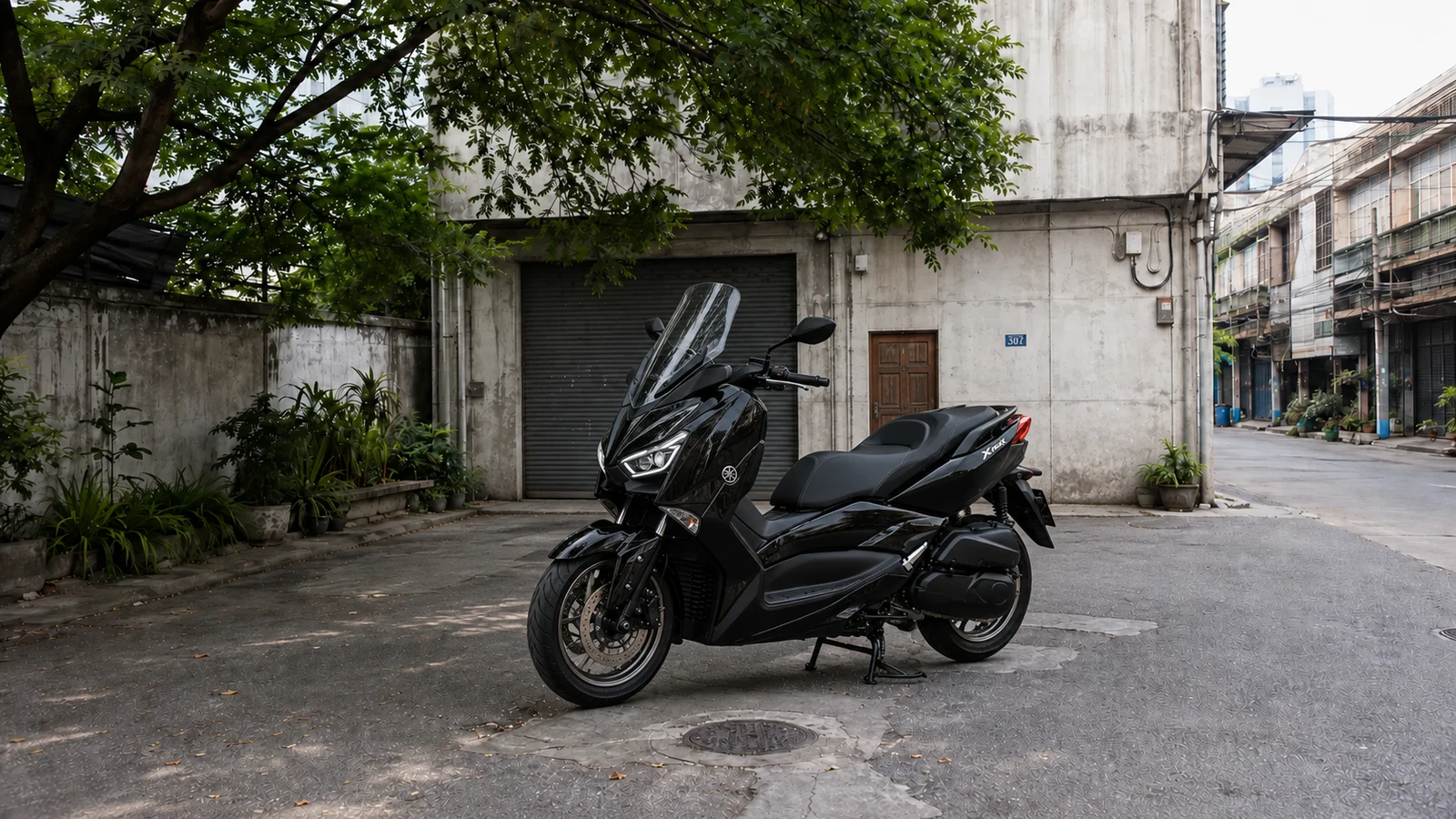 Yamaha XMAX 300 front three quarter in the Charoen Krung courtyard during daytime
